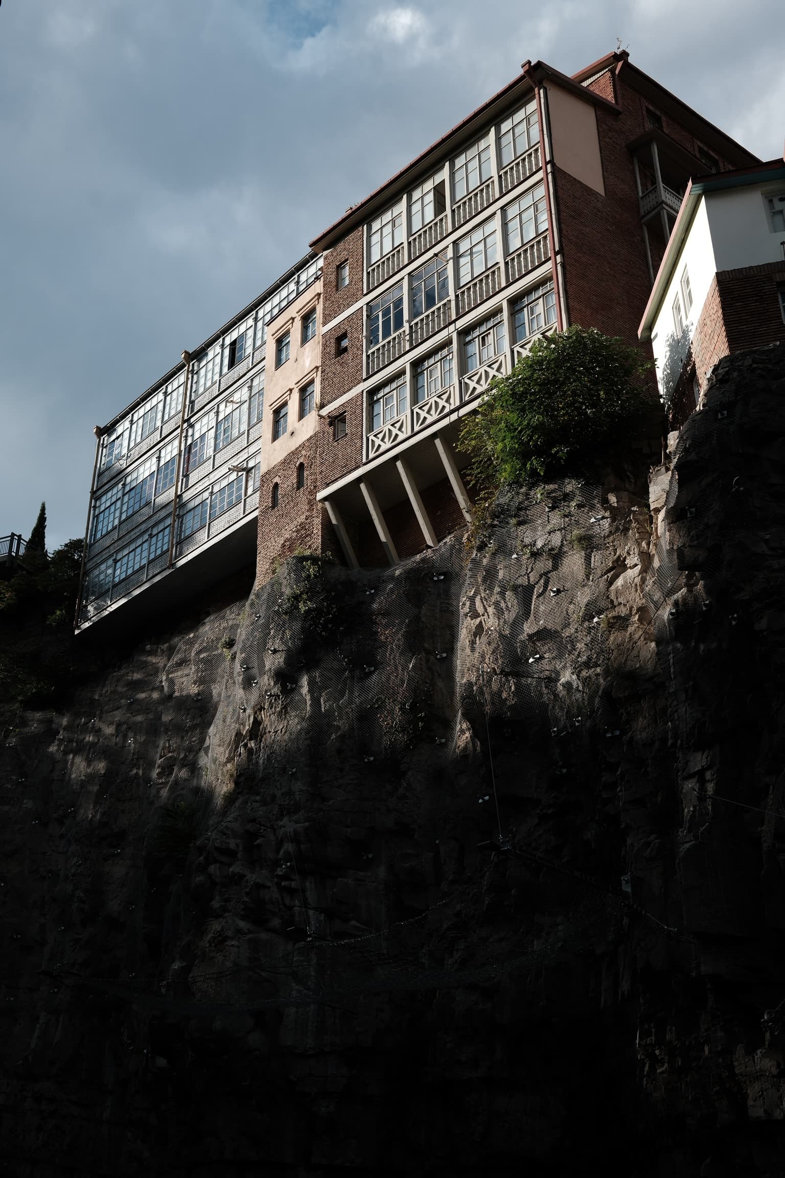 Tbilisi old town - building perched on the cliff above the Narikala river